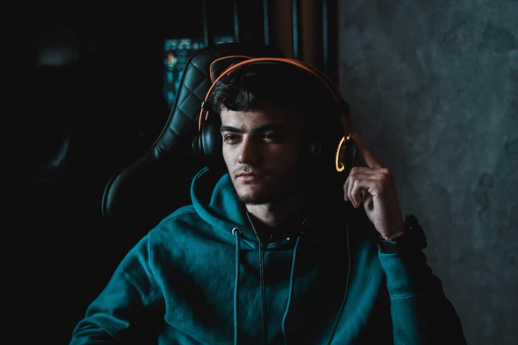 man in black hoodie wearing black headphones